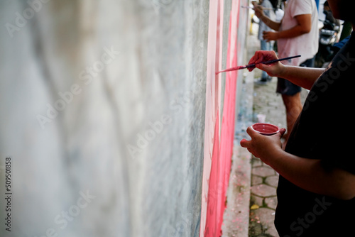 Artist hand drawing paint on the wall