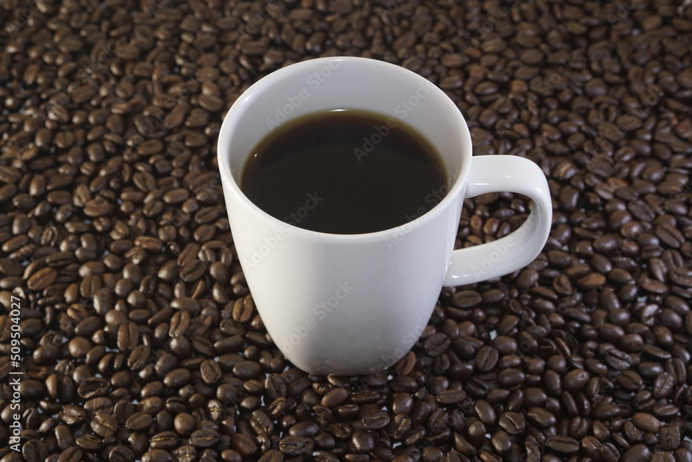 Cup of coffee and coffee beans, caffeine Cup of coffee and coffee beans, caffeine