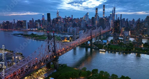 New York in lights at evening time. Beautiful Queensboro Bridge with green park and parking lot under. View from top. photo