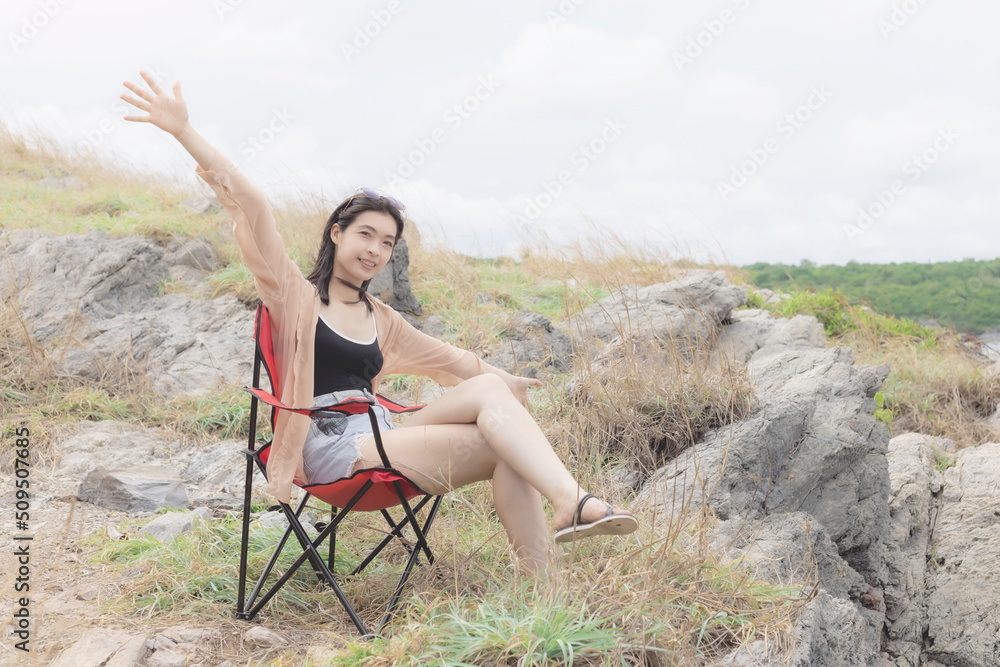 Woman sitting on a chair and shake right hand to say hello. Woman sitting on a chair and shake right hand to say hello.