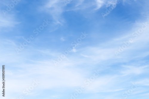 Vast blue sky with light clouds on background