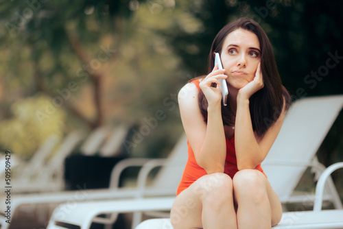 Foto Concerned Stressed Woman Speaking on the Phone by the pool