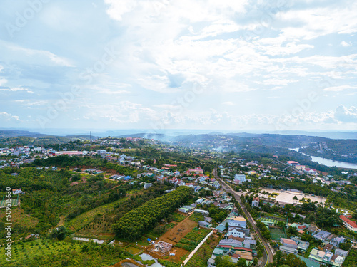 Aerial view of National Route 14 in Kien Duc town, Dac Nong province, Vietnam with hilly landscape and sparse population around the roads.