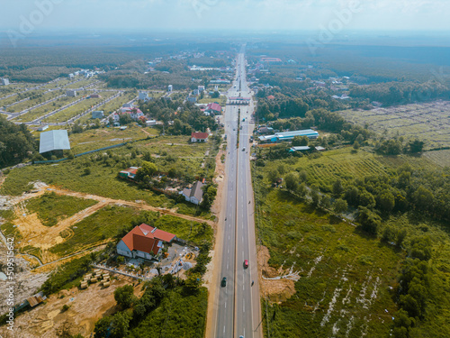 Aerial view of National Route 14 in Binh Phuoc province, Vietnam with hilly landscape and sparse population around the roads photo