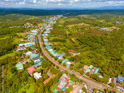 Aerial view of National Route 14 in Kien Duc town, Dac Nong province, Vietnam with hilly landscape and sparse population around the roads.