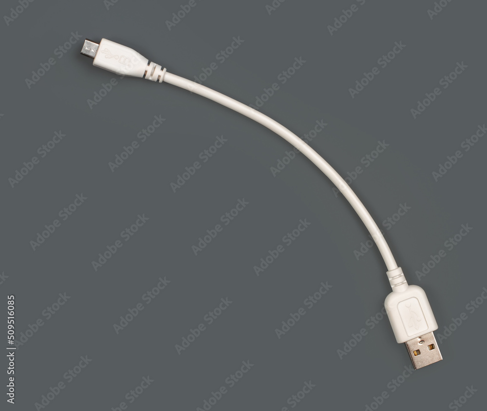 White USB cable on a gray background. White USB cable on a gray background.