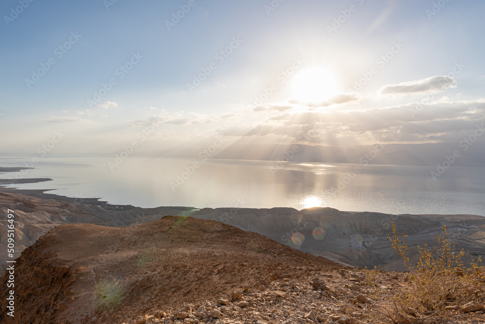 Sunrise  over the Dead Sea near mountains of stone desert near the Khatsatson stream, on the Israeli side of the Dead Sea, near Jerusalem in Israel