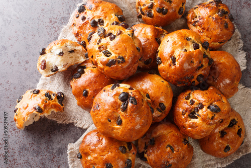 Delicious dutch buns with raisins and currants close-up on the table. horizontal top view from above
