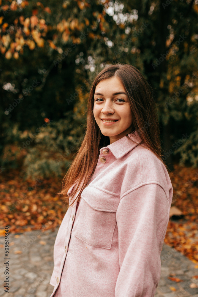 Autumn portrait of young attractive woman who smiles happily on walking walk on warm autumn day in flying park. Indian summer. Weekend. Walking in fresh air. Autumn portrait of young attractive woman who smiles happily on walking walk on warm autumn day in flying park. Indian summer. Weekend. Walking in fresh air.
