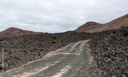 A road built between the solidified lava of a volcano. Lanzarote. Canary Islands, Spain
