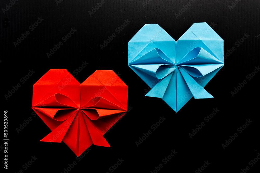 colored hearts made of paper on a black background. love concept colored hearts made of paper on a black background. love concept