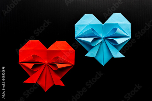 colored hearts made of paper on a black background. love concept