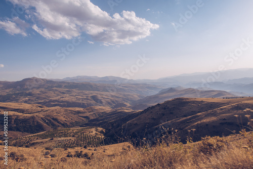 Picturesque Armenian autumn landscape in the backgrounds. Fields and meadows in the mountains of Armenia region. Marvelous blue sky and clouds. Stock photography