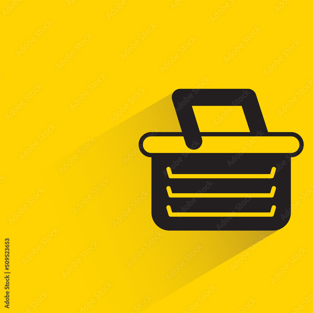 shopping basket with shadow on yellow background shopping basket with shadow on yellow background
