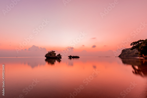 Peaceful seascape at dusk in pink shades.