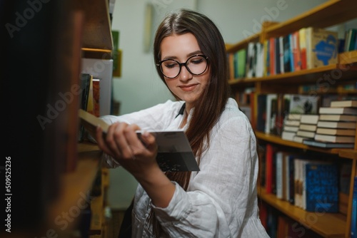 Education, high school, university, learning and people concept. Smiling student girl reading book