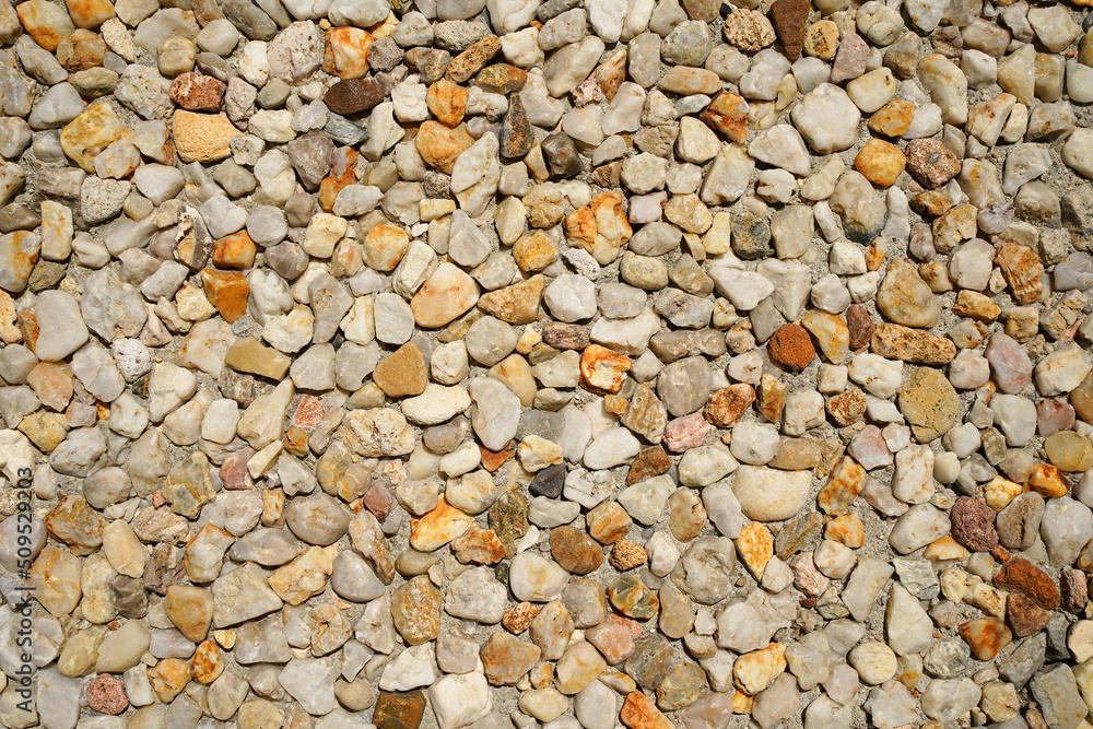 Texture of small stones. Natural background of macadam. Warm rusty color