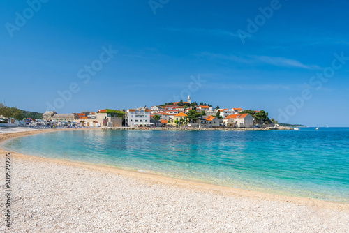 Sand beach in front of old town of Primosten, Dalmatia, Croatia, Europe