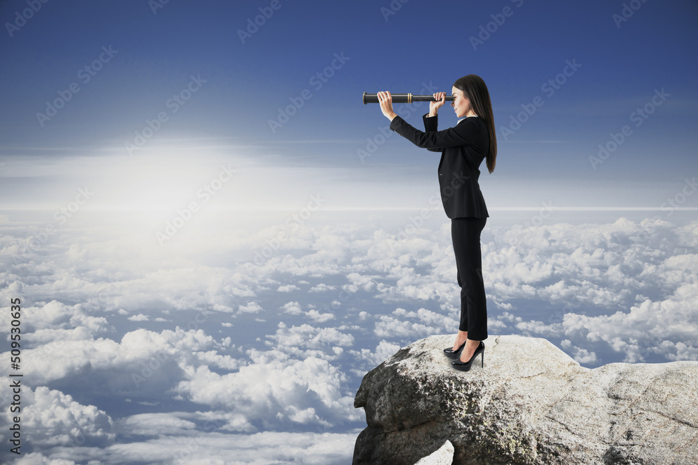 female with telescope standing on cliff and looking into the distance on bright blue sky and clouds background with mock up place for your advertisement. female with telescope standing on cliff and looking into the distance on bright blue sky and clouds background with mock up place for your advertisement.