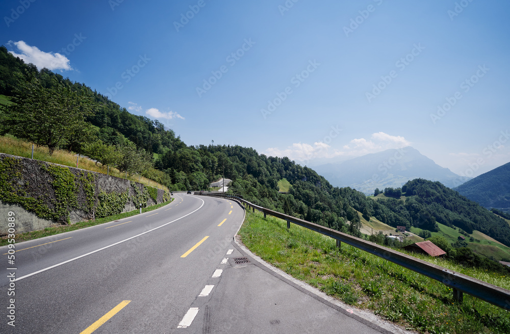 Naklejka premium Asphalt road in Alp mountains. Road trip concept. Beautiful landscape.