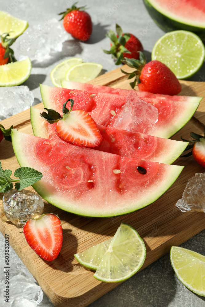 Tasty fresh fruits with ice on gray textured table Tasty fresh fruits with ice on gray textured table