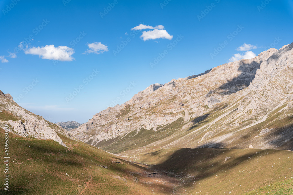mountainous landscape of dry grass with the shadow of the clouds in te mountains mountainous landscape of dry grass with the shadow of the clouds in te mountains