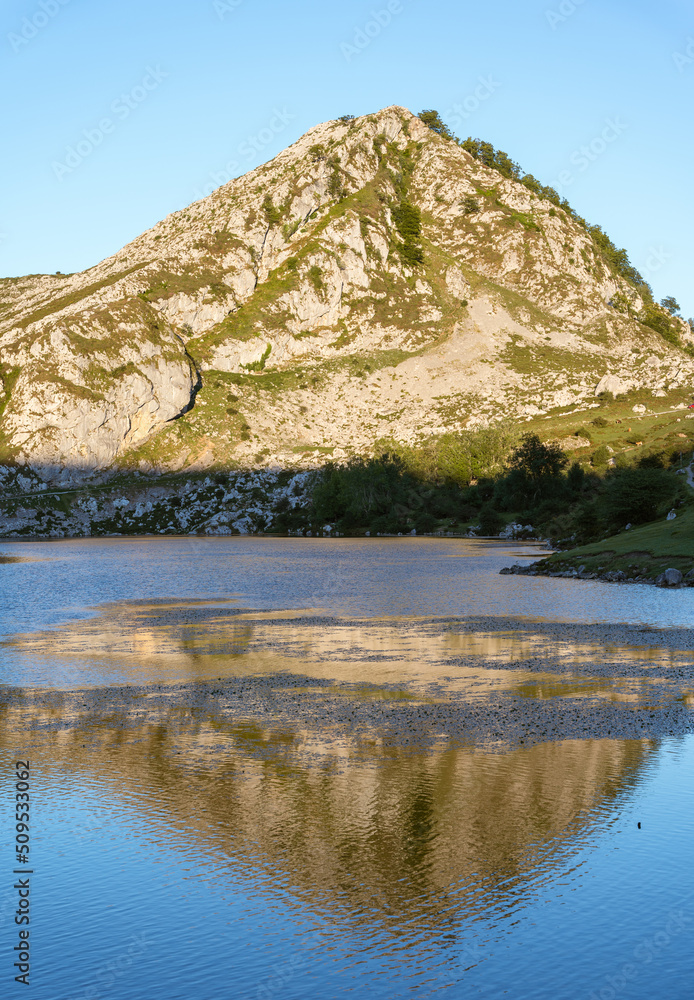 mountain with the light of dawn reflecting on a lake