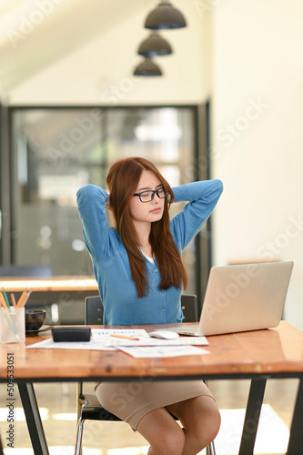Woman stretches her arms when tired in the office, business woman relaxes, office syndrome.