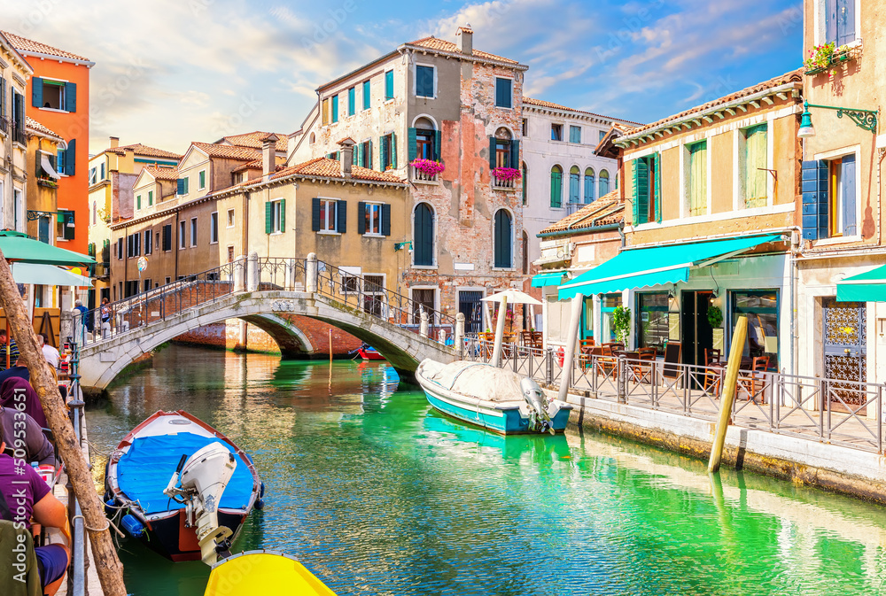 Medieval Bridge, Cafe and colorful houses in the Grand Canal, Venice, Italy