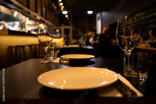 Empty white plate in restaurant setting
