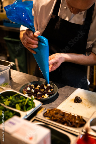 Chef applying finishing touches to meal