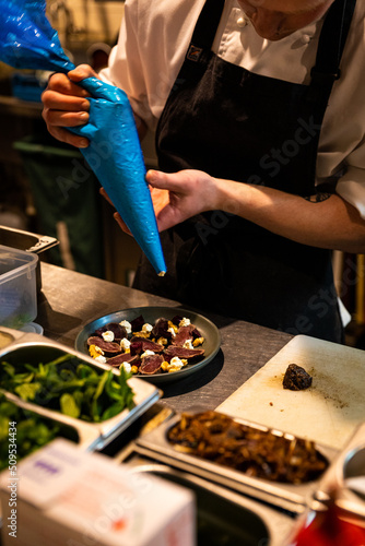 Chef adding finishing touches to plate