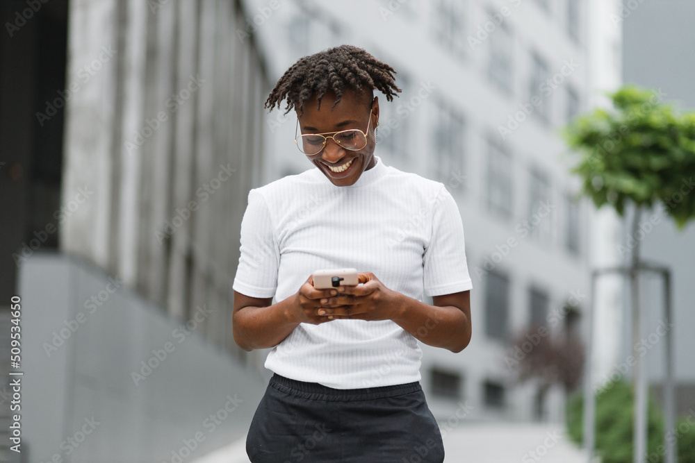 Low angle view of beautiful african woman standing near modern