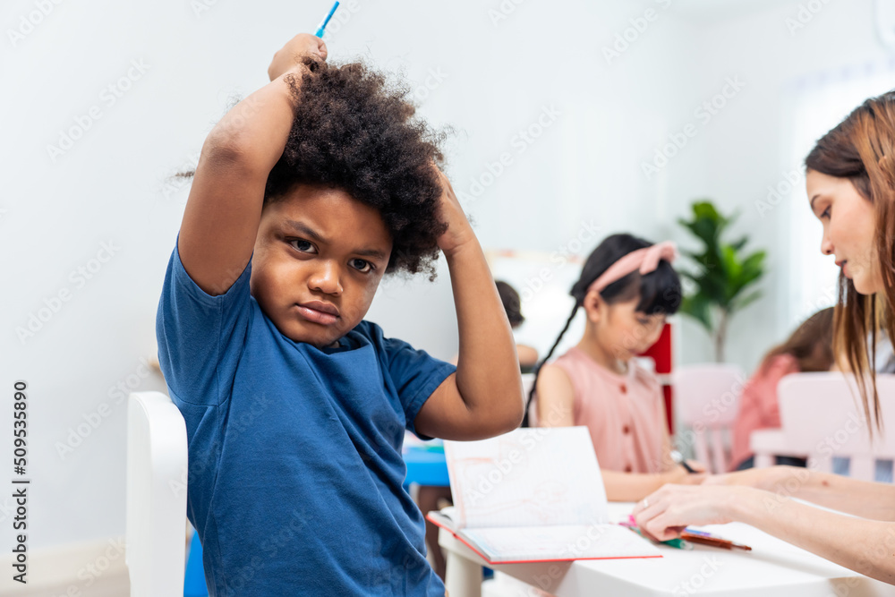 Portrait of Stressed African black child boy learning in class room. Portrait of Stressed African black child boy learning in class room.