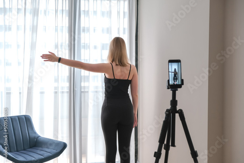 Fit home. woman doing exercises, pilates, exercising in the living room. Concept of sport and leisure, wellness.remote training, home fitness,workouts tracking