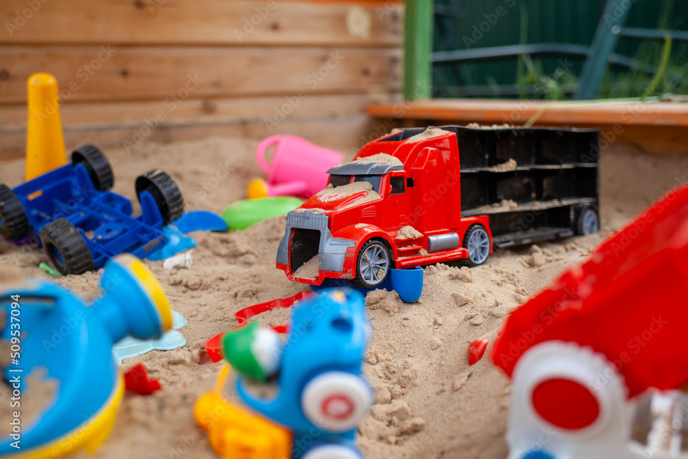 custom made wallpaper toronto digitalSandbox outdoor. Children's wooden sandbox with various toys for the game. Summer concept. Colored toys and cars on the children's sandbox. Selective focus with shallow depth of field