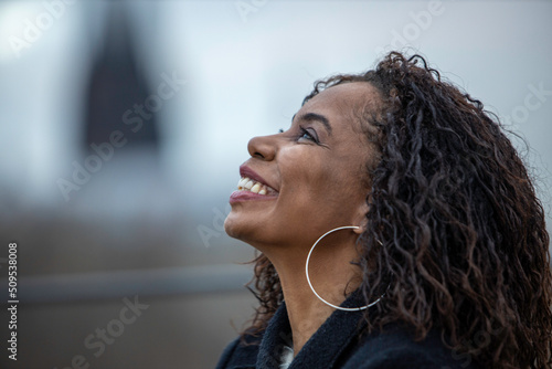 Portrait of afro american woman in urban background. Cologne city, Germany
