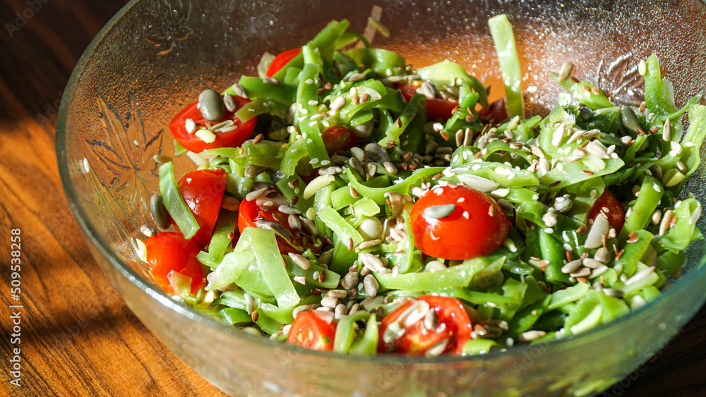Green beans salad with tomatoes, sunflower seeds, flax seeds, and sesame. 