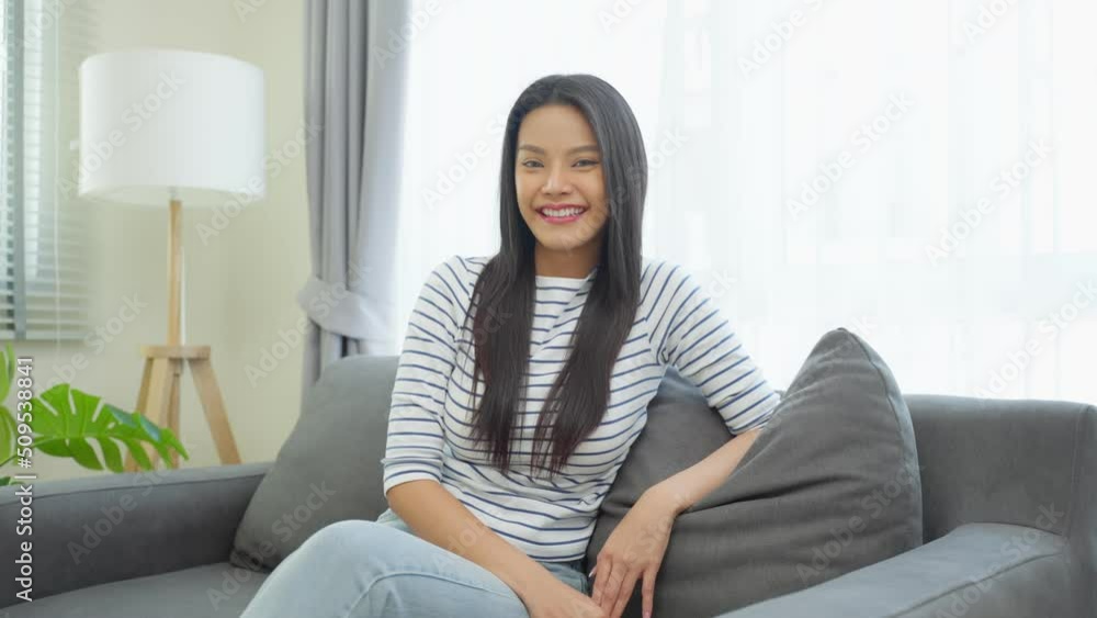 Portrait of Asian beautiful woman sit on sofa in living room at home. Portrait of Asian beautiful woman sit on sofa in living room at home.