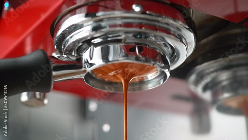 Espresso Extracted through Bottomless Portafilter in Red Coffee Maker in Slow Motion