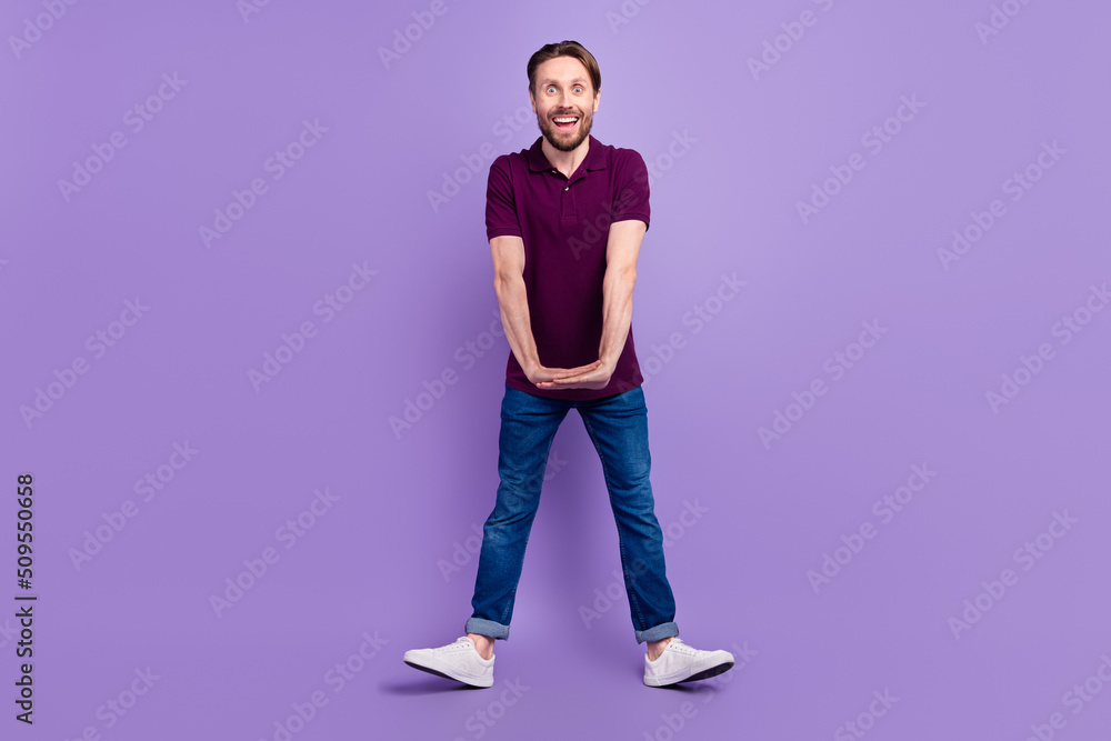 Full size photo of young cheerful man have fun dance fooling childish isolated over violet color background Full size photo of young cheerful man have fun dance fooling childish isolated over violet color background