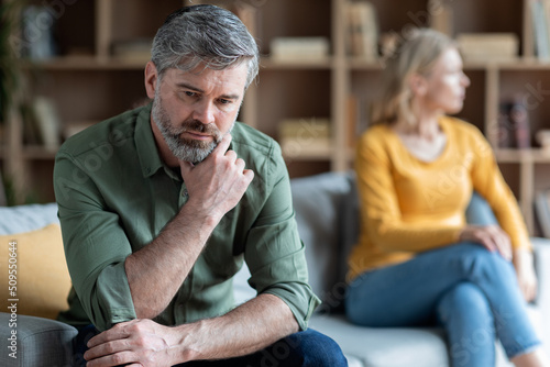 Relationship Crisis. Middle Aged Couple Sitting Offended On Couch After Argue