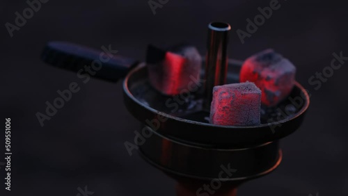 Burning red coals for hookah, hookah cooking at home, ashes, dark interiors