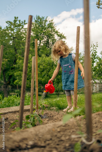 Little blonde girl gardening