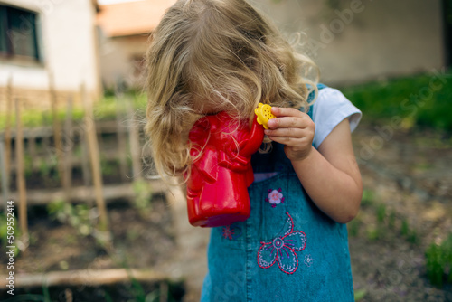 Little blonde girl gardening
