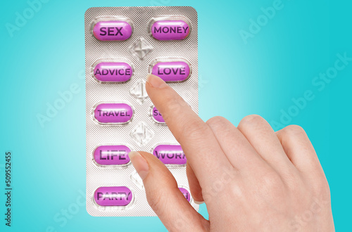 Female hand choices purple pill of medicine that fulfill dreams, desires and wishes. Blue background. The concept of choice and drugs