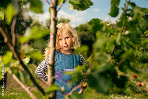 Little blonde girl gardening