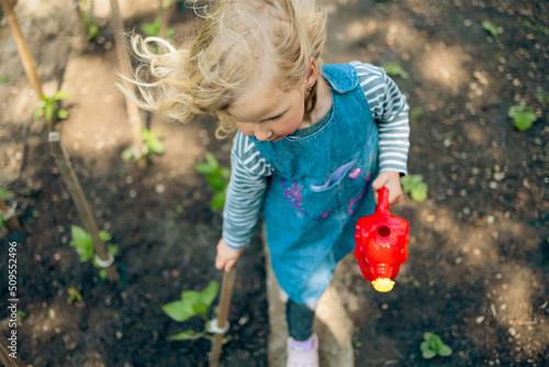 Little blonde girl gardening