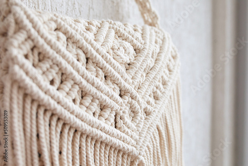 Handmade macrame cotton сross-body bag. Eco bag for women from cotton rope. Scandinavian style bag.  Creme tones, sustainable fashion accessories. Details. Close up 