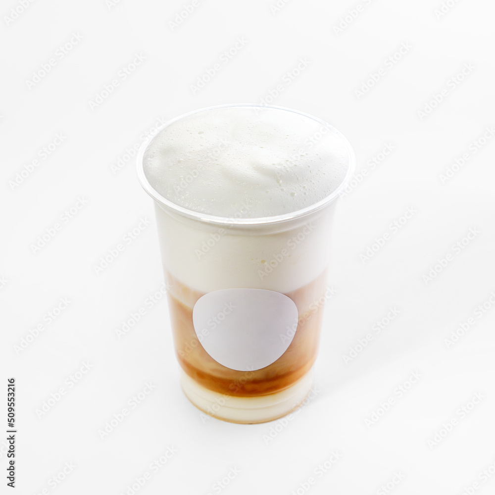 Plastic cup with hot cappuccino coffee with foam on a white background, close-up. Mock up Plastic cup with hot cappuccino coffee with foam on a white background, close-up. Mock up